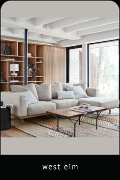 a living room filled with lots of furniture and bookshelves next to a window