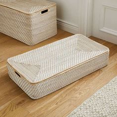 two baskets sitting on the floor next to each other