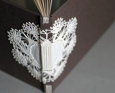 an open book with white lace on it