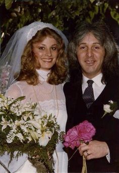 a bride and groom pose for a wedding photo