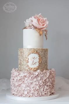 a three tiered cake with pink and gold ruffles