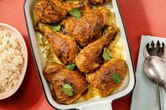 a casserole dish filled with chicken and rice next to a bowl of rice