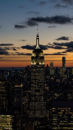 the empire state building lit up at night in new york city, ny with its lights on