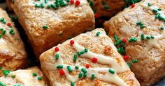 several square pieces of cake with frosting and sprinkles on a plate