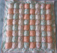 a baby blanket made out of several different types of diapers