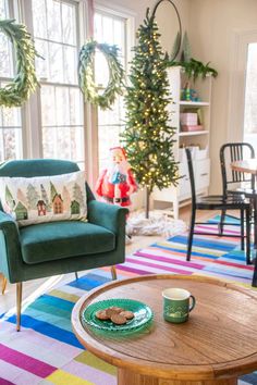 a living room filled with furniture and christmas decorations