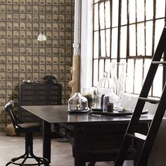 a dining room table and chairs in front of a window with barstools on it