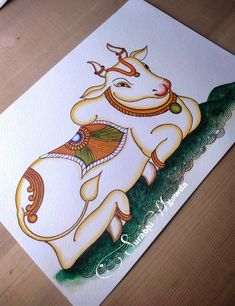 a card with an image of a cow on it's back, sitting on a table