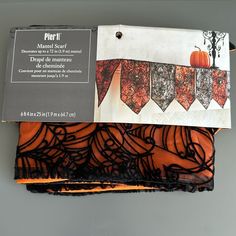 an orange and black piece of cloth with lace on it, sitting in a box