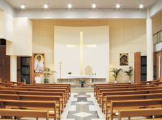 the inside of a church with wooden pews