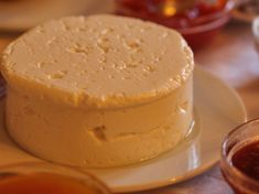 a white cake sitting on top of a plate