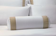 white and tan bedding with pillows on it