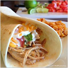 a tortilla filled with meat, cheese and vegetables