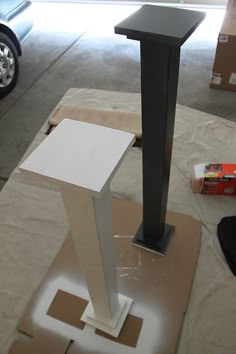 a tall white object sitting on top of a cardboard box