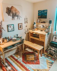 a living room filled with lots of furniture and art on the wall next to a window