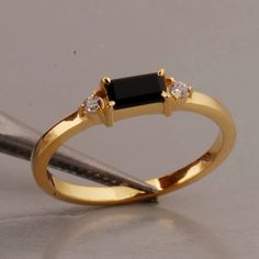 "Minimalist Ring, 18k Gold Vermeil, Black Onyx Baguette Ring, Engagement Ring, Stacking Ring, Black Onyx Ring, Dainty Ring, Rings For Women  SHOP LINK:- https://www.etsy.com/shop/MaaShabashibaJewell?ref=seller-platform-mcnav 》D E T A I L S《 Gemstone: Natural Black Onyx                  Gem Color: Black                      Gem Shape: Baguette                         Gem Category: Cut                    Metal: 925 Sterling Silver Purity: 925 Parts Per 1000 Setting Type: Prong Set Silver Polish: High Ring Size: All Size Available Please note that there Can be slight variations in stone texture and color shades in the actual product that you receive. The stone quality or grade will be the same. Because We Use Natural Stones And All Natural Stones Are Not Of Same Textured. All Our Jewelry Is 9 Baguette Ring Engagement, Engagement Ring Stacking, Black Gold Ring, Black Gems, Zierlicher Ring, Baguette Ring, Silver Polish, Ring Stacking, Black Onyx Ring