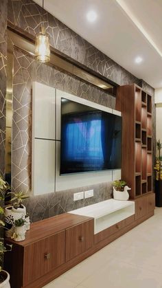 a large flat screen tv mounted to the side of a wooden cabinet in a living room