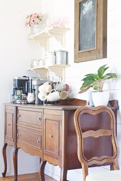 a wooden desk with a chalkboard on the wall above it