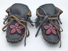 Men's or women's genuine buffalo leather moccasins with a securely sewn hand-beaded floral design.  These moccasins were authentically and beautifully handmade (all hand stitching) by Anishinaabe/ Ojibwe tribal artisans, Amy Clark, Heather Romero and Angel Roy of Pine Point Village, which is located within the White Earth Nation Reservation in Northern Minnesota.  The moccasins are 9 1/2 inches long and 4 inches wide.  Size 8/9 women's.  Size 7/8 men's. Artisan Hand-stitched Moccasins With Round Toe, Artisan Hand-stitched Round Toe Moccasins, Traditional Brown Hand-stitched Moccasins, Handmade Traditional Leather Moccasins, Indian Moccasins, Beaded Buffalo, Earth Nation, Pine Point, Beaded Moccasins