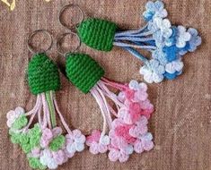 three crocheted flowers and two pairs of scissors on a brown surface with text overlay