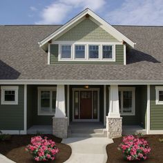 a house with green siding and white trim