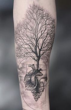 a tree and heart tattoo on the leg