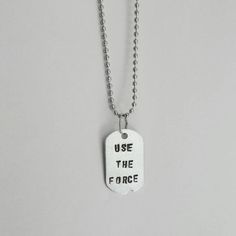 a dog tag with the words use the force on it is hanging from a chain