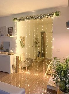 a living room filled with furniture and christmas lights on the wall above it's doorway