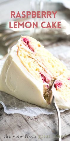 a piece of cake with white frosting and raspberries