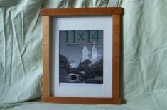 a wooden frame holding a book titled 11x11