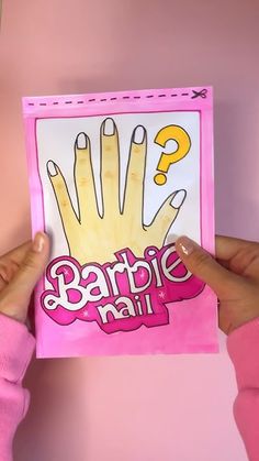 someone is holding up a barbie doll's handprinted nail art card with question marks on it