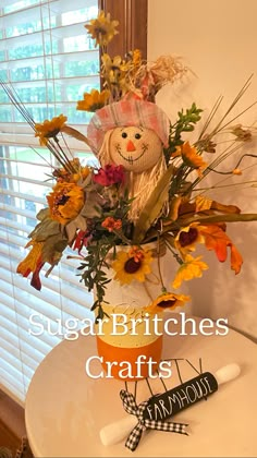 a vase filled with flowers sitting on top of a white table next to a window