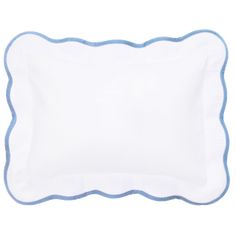 a white and blue pillow with scalloped edges on a white background, it has a light blue trim around the edge