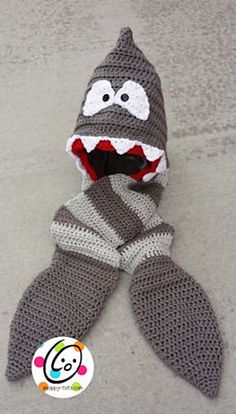 a crocheted stuffed animal with a mouth and teeth on it's face