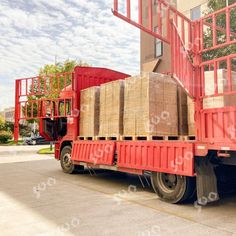 a red truck is loaded with wooden boxes