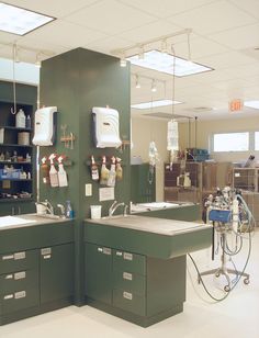 two sinks are shown in the middle of a large room with shelves on each side