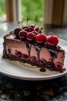 a slice of chocolate cake with cherries on top