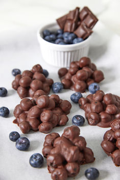 chocolate and blueberries are scattered on a table