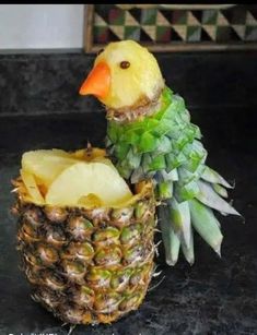 a pineapple with a duck in it's head sitting on top of another pineapple