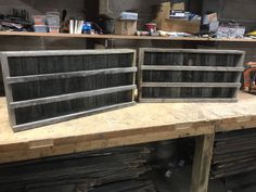 two wooden crates sitting on top of a workbench