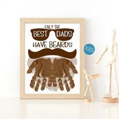 a wooden mannequin next to a framed poster with the words best dads have beards on it