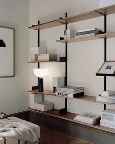 a bookshelf filled with lots of books on top of wooden shelves