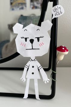 a paper cut out of a girl and a bear