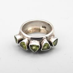 This is a beautiful Vintage Sterling Silver Ring set with 5 Triangular (trillion) Peridot Stones.  This ring is a lovely piece of vintage jewellery. The silver surface is lightly patinated and polished. The stones are set in rub-over settings This is a gorgeous piece which will definitely be noticed when worn. Stamped: 925 Size: inner diameter 17.2mm, UK size N 1/2, Europe size 54, US size 7 Width: 9.3mm Weight: 8.9g Please note: ALWAYS measure your ring size accurately before ordering as I cannot accept returns based on the choice of the wrong ring size. If in doubt about your size, please take the exact inside diameter of a ring you own and that fits you well. Alternatively, have your ring size measured by a jeweller. Please feel free to message me any questions. I am happy to ship to Eu Sterling Silver Rings Set, Silver Ring Set, Vintage Sterling Silver Rings, Peridot Stone, Multi Stone Ring, Vintage Jewellery, The Choice, Vintage Sterling Silver, Stone Rings