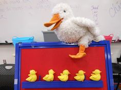 a stuffed duck sitting on top of a red board