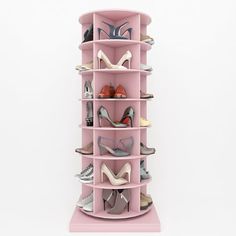 a pink shoe rack with several pairs of shoes on top and bottom shelves in the middle