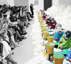 several people sitting in rows with buckets full of snow