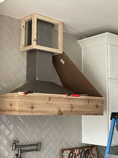 a stove top oven sitting inside of a kitchen next to a wall mounted range hood