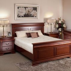 a bed room with a neatly made bed and dressers