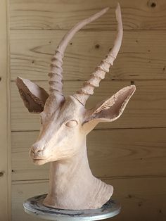 a sculpture of an antelope on a table